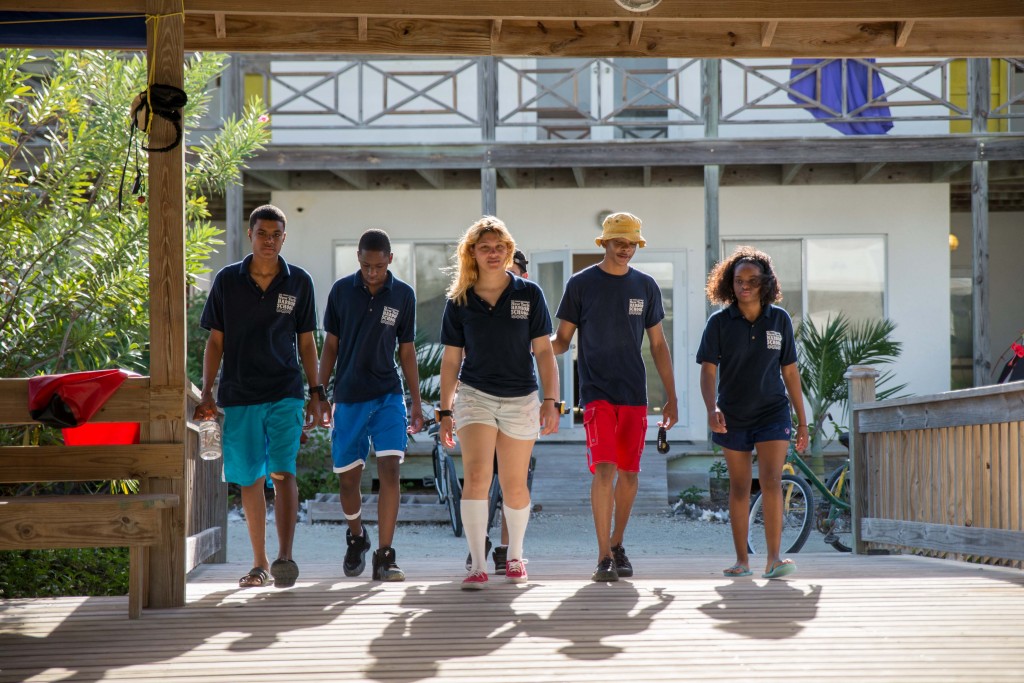 NYHS students entering the boathouse before a morning dive