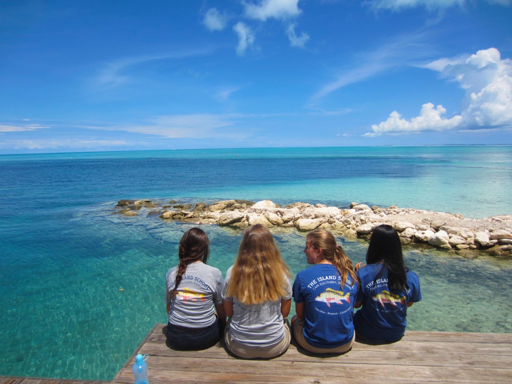 Students sit and enjoy boathouse cut view. 