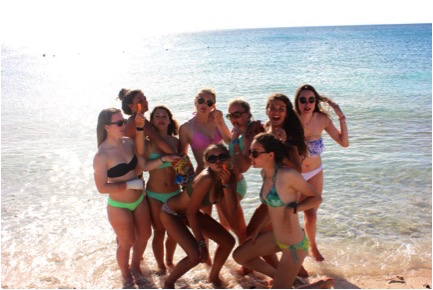 A group of girls hang out at Sunset Beach during exploration. Back row: Sophie, Ali, Maya, Lane, Noelle, Olivia, Nelle. Front row: Madeline, Hanna